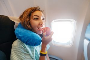 Woman eating an apple on airplane