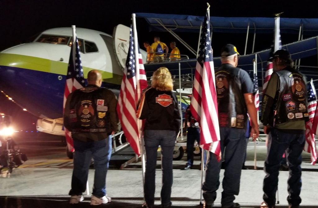 Patriotic greeters wait for US Veterans to disembark from their flight to Washington DC