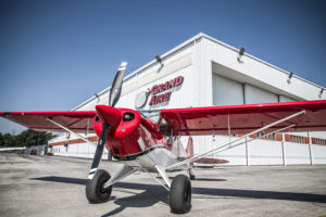 Prop plane in front of Grand Aire hangar