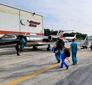 Medical team boarding airplane to transport donated organ to recipient