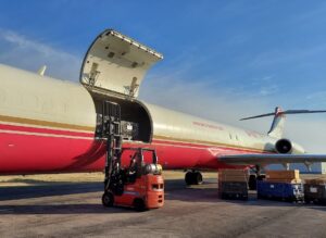 Forklift loading air freight onto a plane