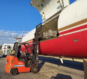 Forklift loading freight onto an airplane