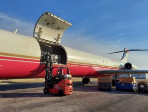 Forklift loading pallets on to a cargo charter plane