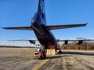 Air freight being loaded onto an airplane by a forklift