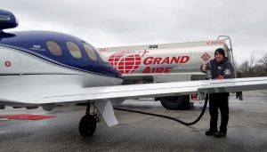 Line Crew worker fueling small airplane at Grand Aire