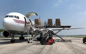 Cargo being loaded onto an airplane via K loader
