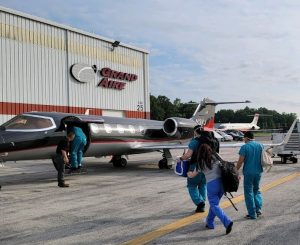 Medical team transporting donated organ onto an airplane