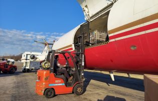 Forklift loading freight onto an airplane