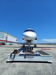 Mototok Aircraft Tug with airplane on airfield at Grand Aire