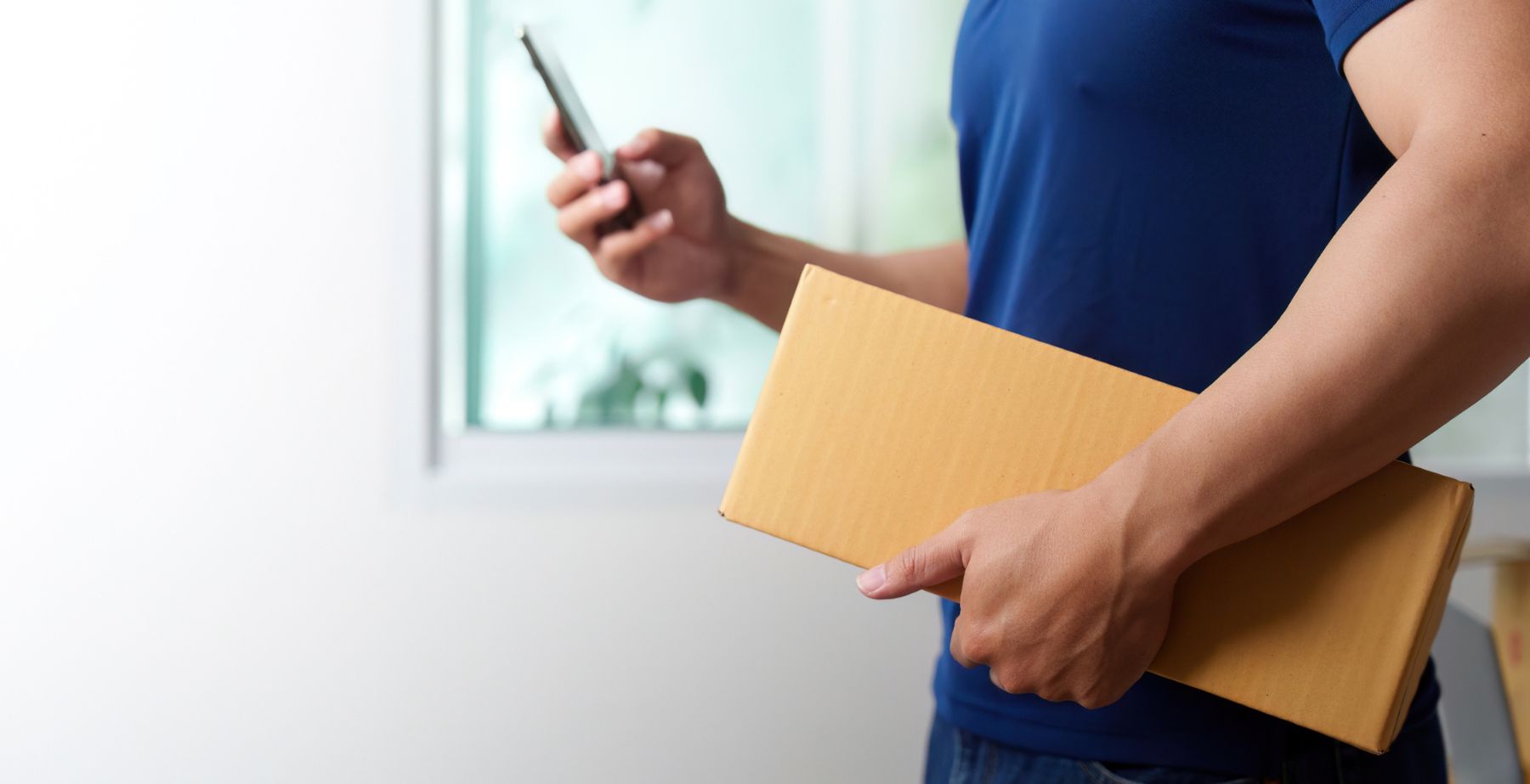 Man hand carrying a box delivery